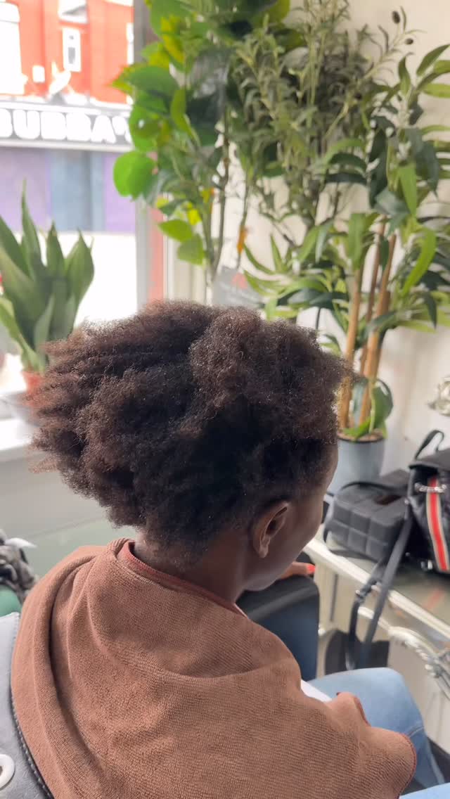 A child’s natural hair, neatly styled