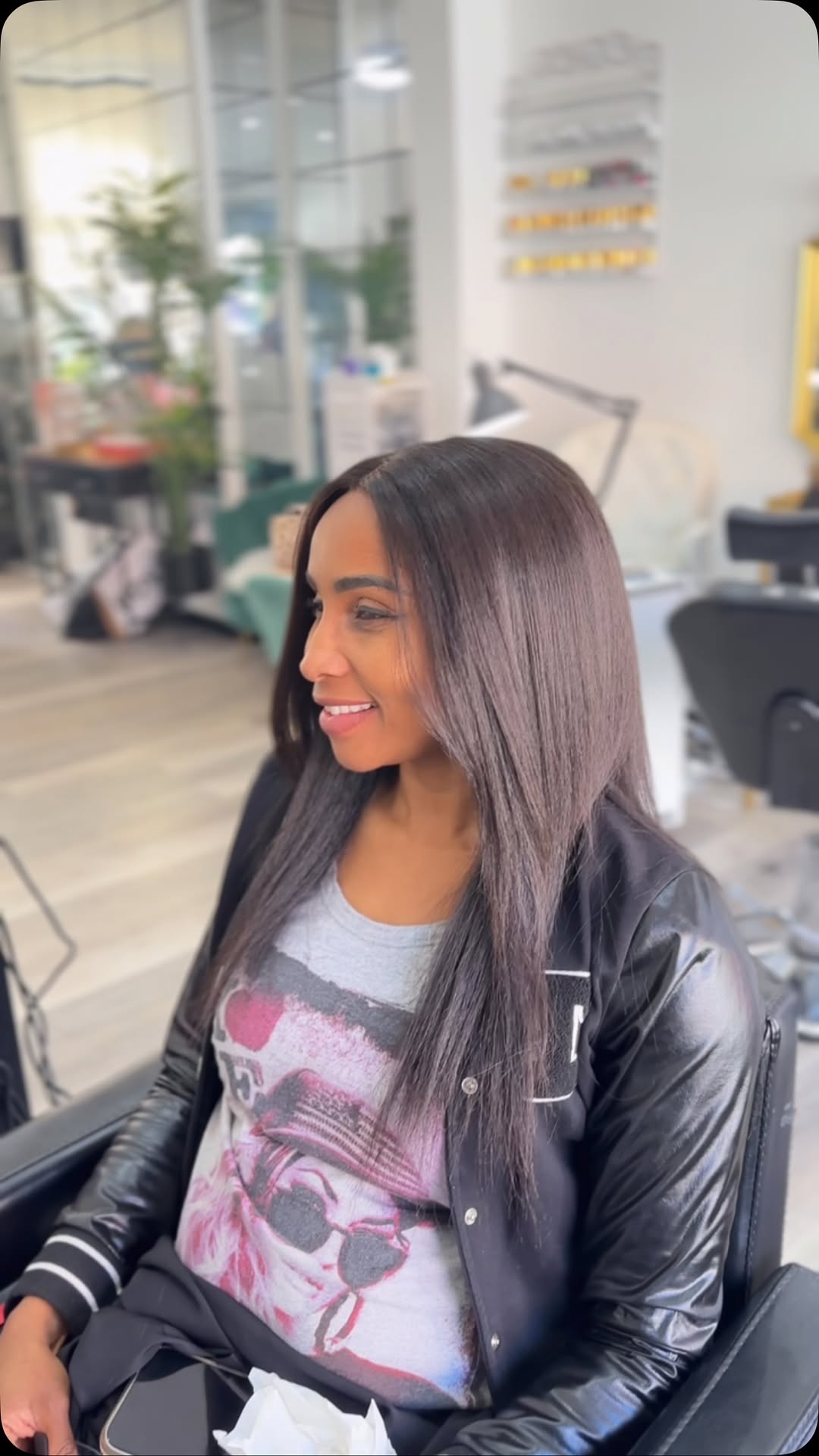 A happy client with a fresh, glossy silk press