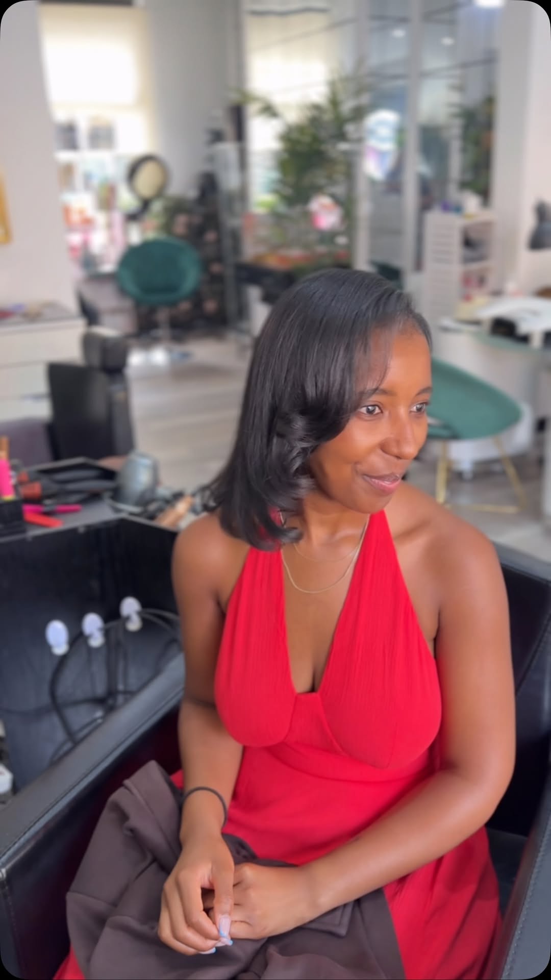 Client smiling after a fresh silk press at Ella Hair & Beauty Salon