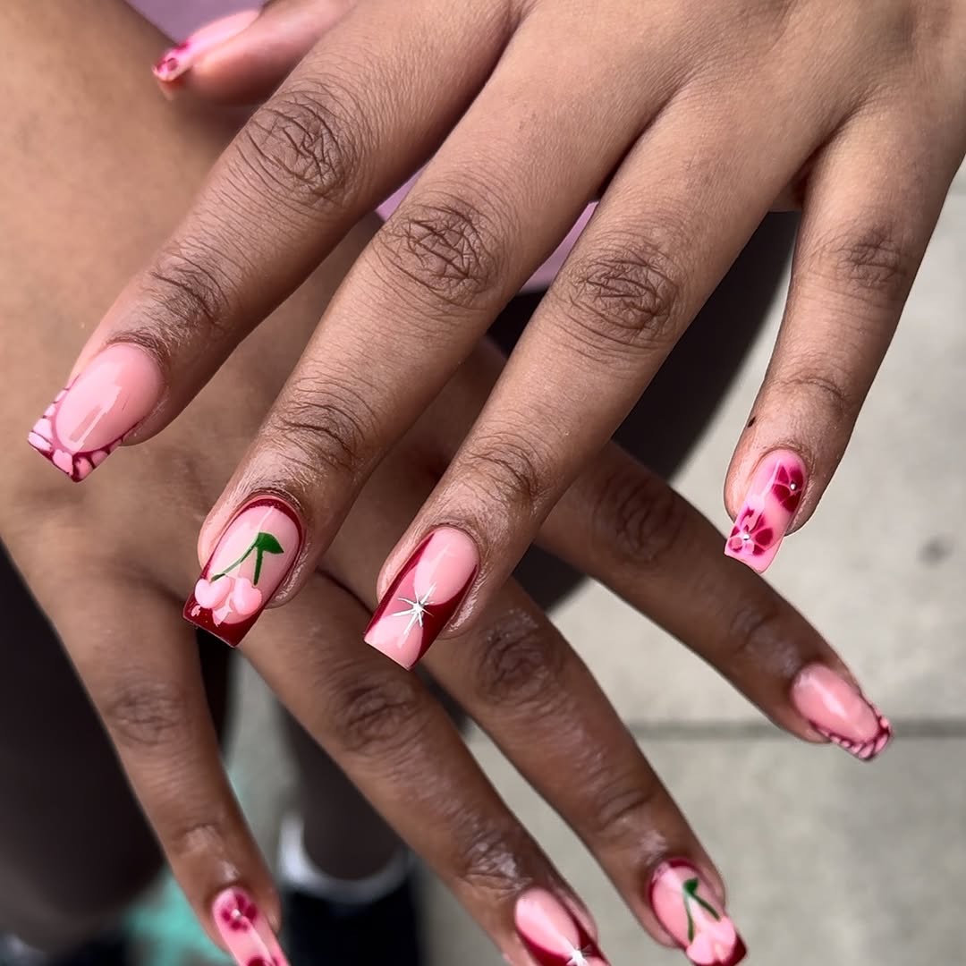 Hand-painted swirl nail art in pink and green